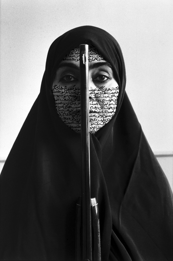 “Rebellious Silence,” one of Shirin Neshat’s works from 1994, portrays a Muslim woman covered, except for her face, by a <i>hijab</i> and holding a shotgun. (photo courtesy of Gladstone Gallery, New York and Brussels) 