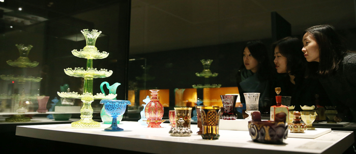 Various colors and shapes of cups and bottles produced in Bohemia. 