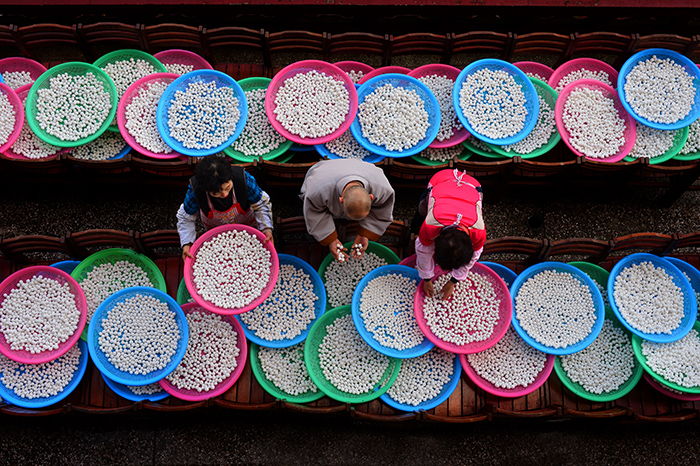 A bronze prize winning photo shows people preparing rice balls to make red bean porridge ahead of the Dongji holiday. The photo was taken at Samgwangsa Temple in Busan.