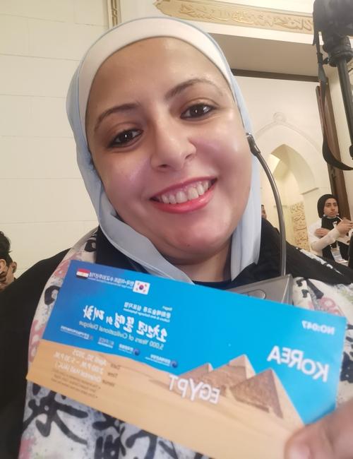صورة لي من قلب الحدث مرتدية سماعة الترجمة الفورية حاملة تذكرتي - الصورة من أمنيه أمير