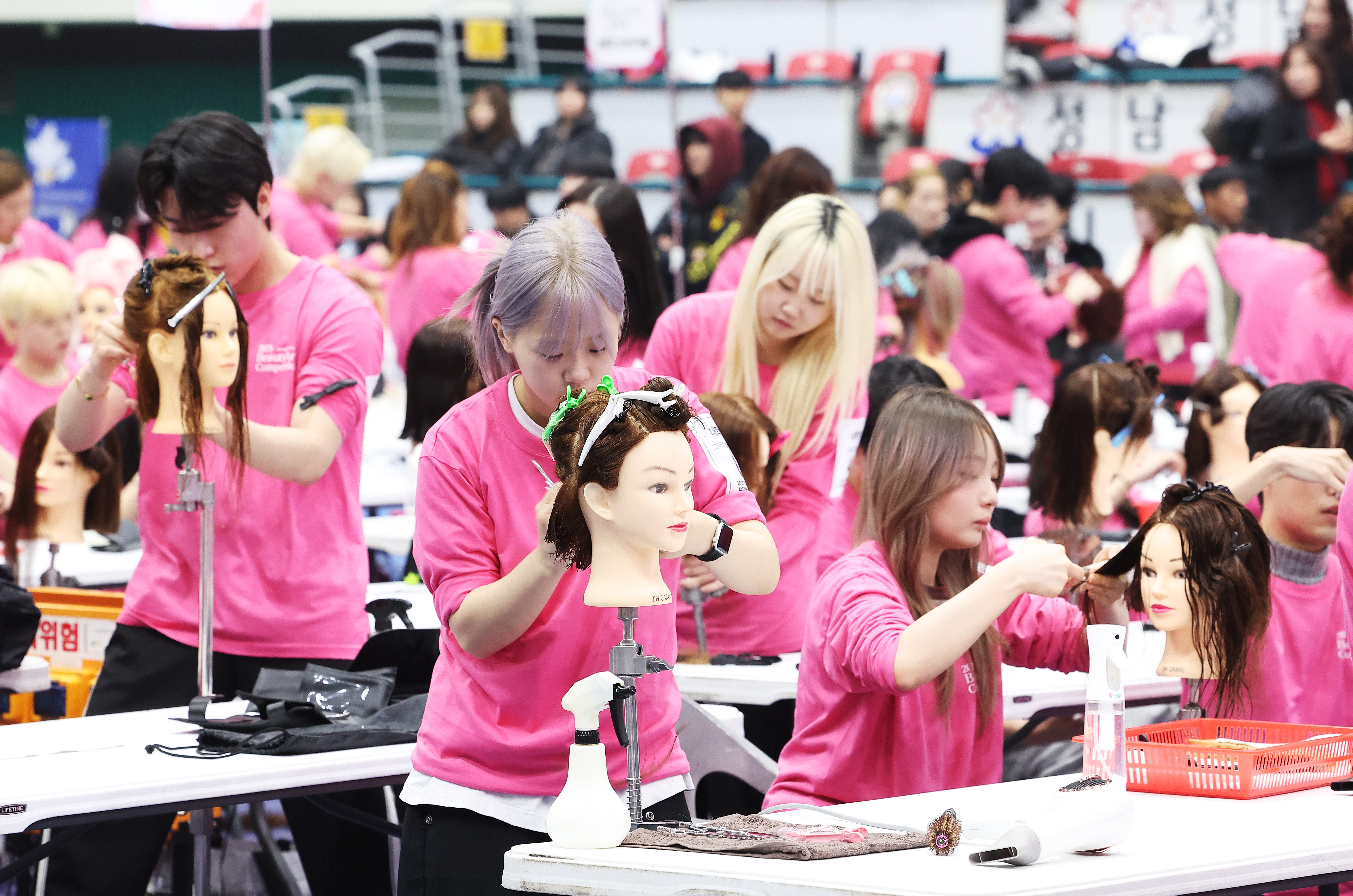 المتسابقون يستعرضون مهاراتهم في مسابقة تصفيف الشعر لعام 2025، أقيمت في صالة سيونغنام الرياضية في جونغوون-غو، بمدينة سيونغنام، مقاطعة غيونغغي في يوم 18 نوفمبر.